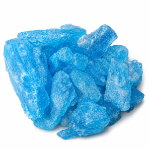 Vibrant sky blue crystalline pieces arranged on a clean white surface